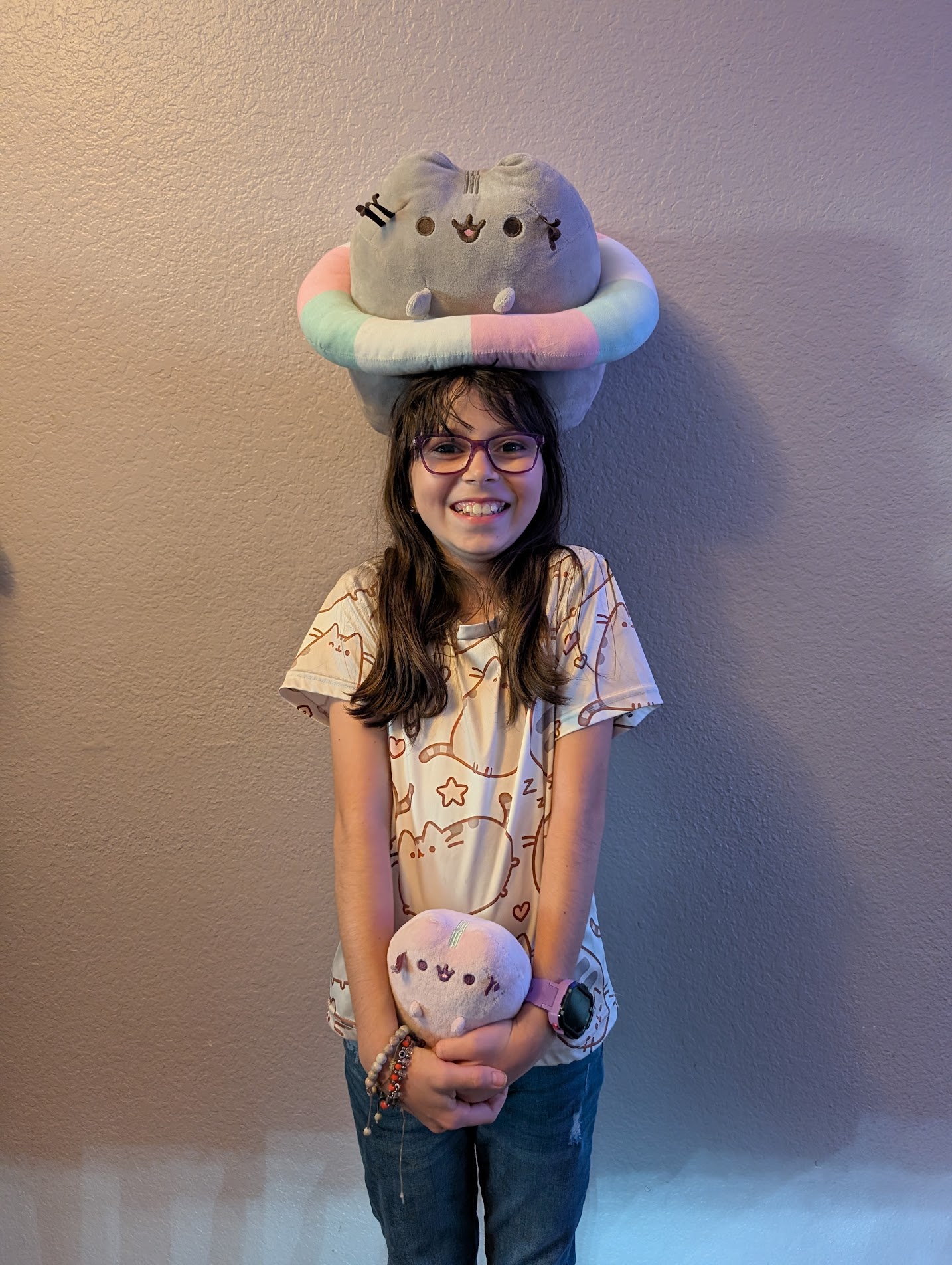 Luna, age 10, smiling brightly with her favorite purple glasses and a pink Minecraft tee